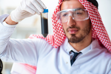 Arab chemist scientist testing quality of oil petrol