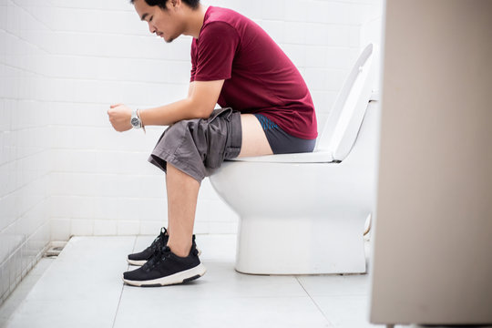 Man sitting in toilet.Diarrhea concept.