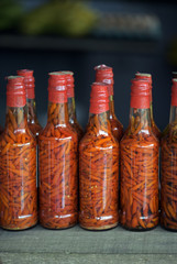 Canned pepper bottles on market stall