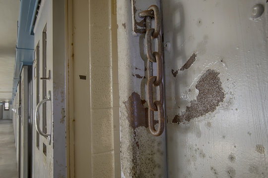 Rusty chains on prison cell door