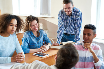 Fototapeta premium College students discussing new subject at the desk at university