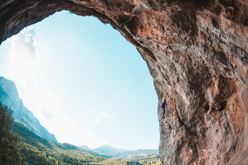 A girl climbs the rock.