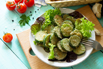 Fried zucchini or cucumber. Fast food on the kitchen table.