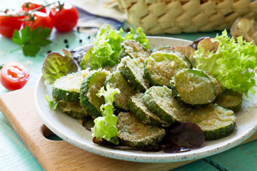 Fried zucchini or cucumber close-up. Fast food on the kitchen table.