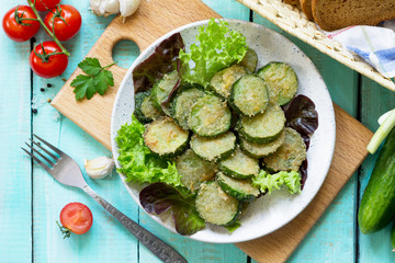 Fried zucchini or cucumber. Fast food on the kitchen table. Top view flat lay background.