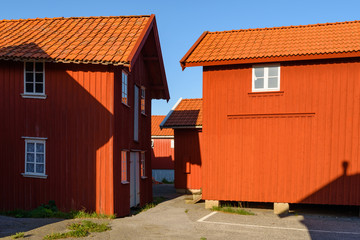 Old red wooden storage buildings in the harbor district of the village Mollosund on Orust, Sweden.