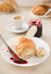 Fresh breakfast at morning. Croissant with jam and coffee.