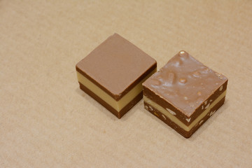 two chocolate candies on a gray background