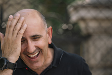 Bald man shows his funny head.