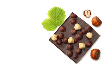 chocolate with hazelnuts and leaves isolated on white background. top view