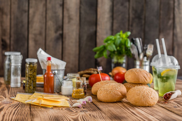 Tasty hamburger with meat and vegetables against a dark background. Fast food. It can be used as a background