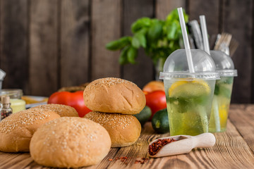 Tasty hamburger with meat and vegetables against a dark background. Fast food. It can be used as a background