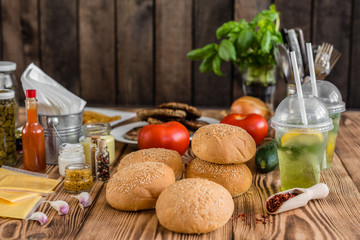 Tasty hamburger with meat and vegetables against a dark background. Fast food. It can be used as a background