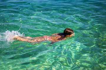 Girl enjoying diving in beautiful Croatian sea. 