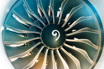 Close up of turbojet of aircraft turbine engine fan civil with a gradient of colors from cold to warm.