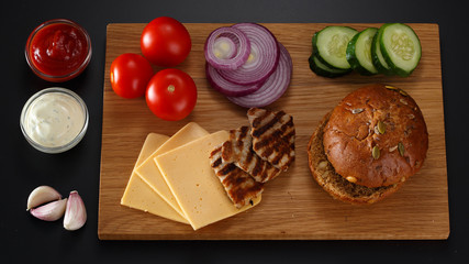 Ingredients for a sandwich on a black background.