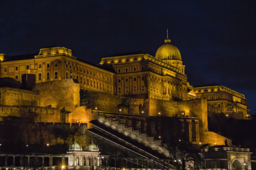 Fototapeta na wymiar View over Buda side of Budapest with illuminated Buda castle and Danube river from viewpoint on a touristic motor ship at night in Budapest, Hungary