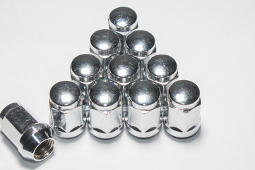 Car service, nut of fixture of a wheel of the car on a white background,