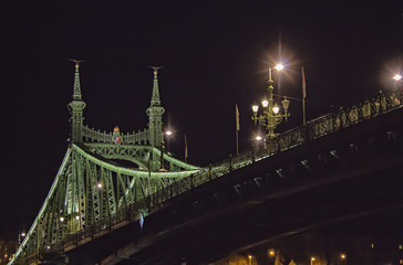 Fototapeta na wymiar View on the Liberty bridge footing of Chain bridge on Danube river at night in Budapest, Hungary