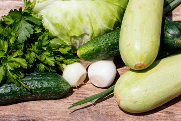 Fresh green vegetables on rustic wooden table outdoor