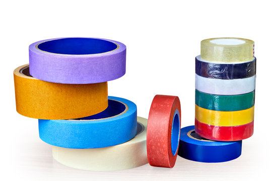 Coils of multi-colored adhesive tape for various purposes on white background.
