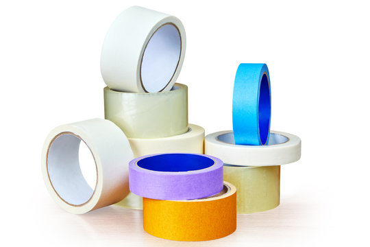 Adhesive tape in stock is stacked on white.