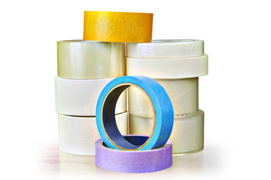Many rolls of adhesive tape stacked pile on white background.