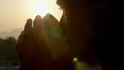 Fotobehang Chocoladebruin Young woman drinking hot coffee on the balcony with beautiful mountain landscape  © alexeg84