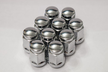 Car service, nut of fixture of a wheel of the car on a white background,