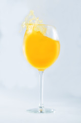Glass of orange juice on a gray background. toning. selective focus