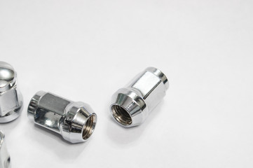Car service, nut of fixture of a wheel of the car on a white background,