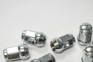 Car service, nut of fixture of a wheel of the car on a white background,