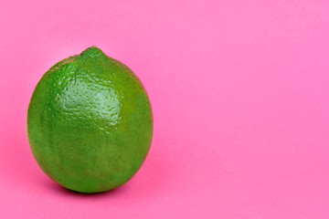 Fresh lime on pink background