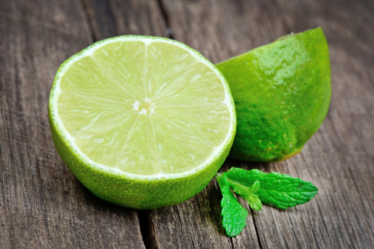 Fresh lime with mint on old table