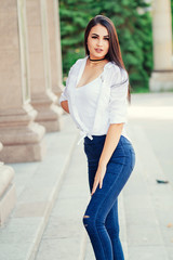 stylish fashionable young girl in white shirt and jeans