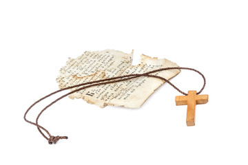Scrap of sheet from an ancient holy book a wooden cross on a cord