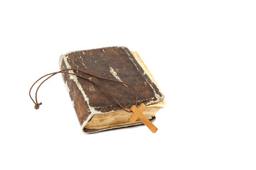 Ancient holy book of a wooden cross on a cord