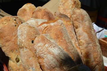 Rustic Artisan bread dusted in flower on bakery market stall.