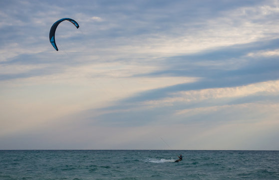 kitesurfer rides a kite-surf on waves of the sea