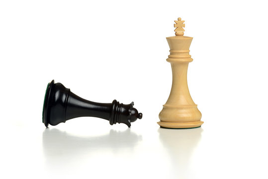 King chess piece standing with black queen defeted