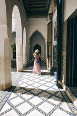 Caucasic girl with long dress and hat at Bay Palace