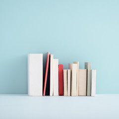 Miniature books on a shelf.