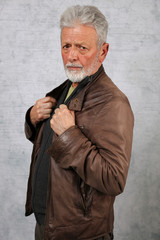 Portrait of stylish senior bearded man wearing leather jacket. Fashion , lifestyle concept