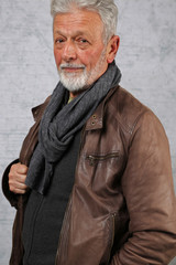 Obraz premium Portrait of stylish senior bearded man wearing leather jacket. Fashion , lifestyle concept