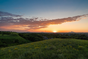 Sunset over the contry side and flowers