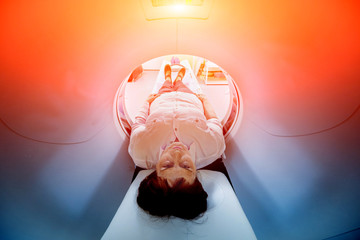 Doctor and patient in the room of computed tomography at hospital.