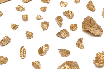 Gold nuggets isolated on the white background. Painted with gold paint granite stones.