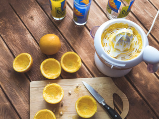close up cut oranges on the board with knife and making fresh juice