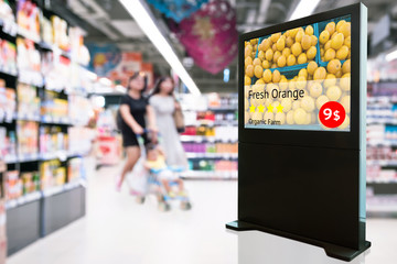 Intelligent Digital Signage , Augmented reality marketing and face recognition concept. Interactive artificial intelligence digital advertisement fresh orange organic farm in retail shopping Mall.