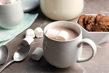 Fototapeta na wymiar Hot cocoa drink with marshmallows in cup on table